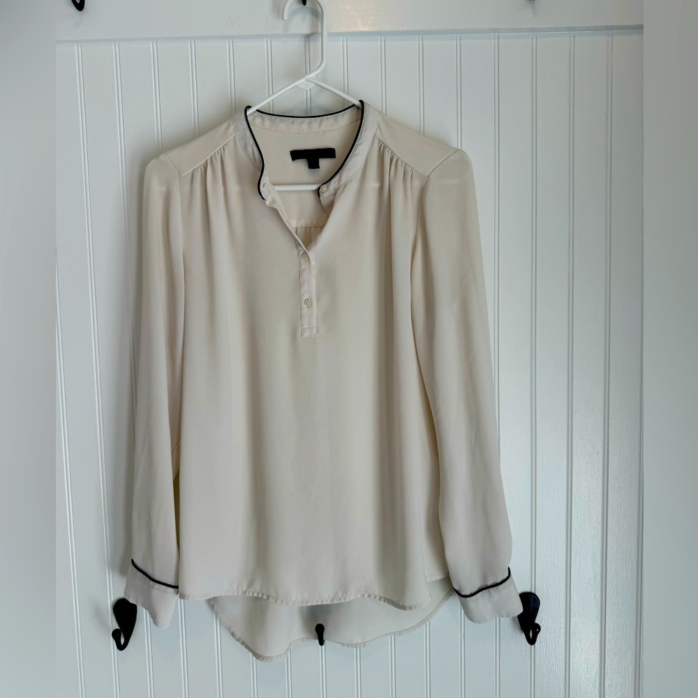 Banana Republic women's size small ivory blouse with black piping.